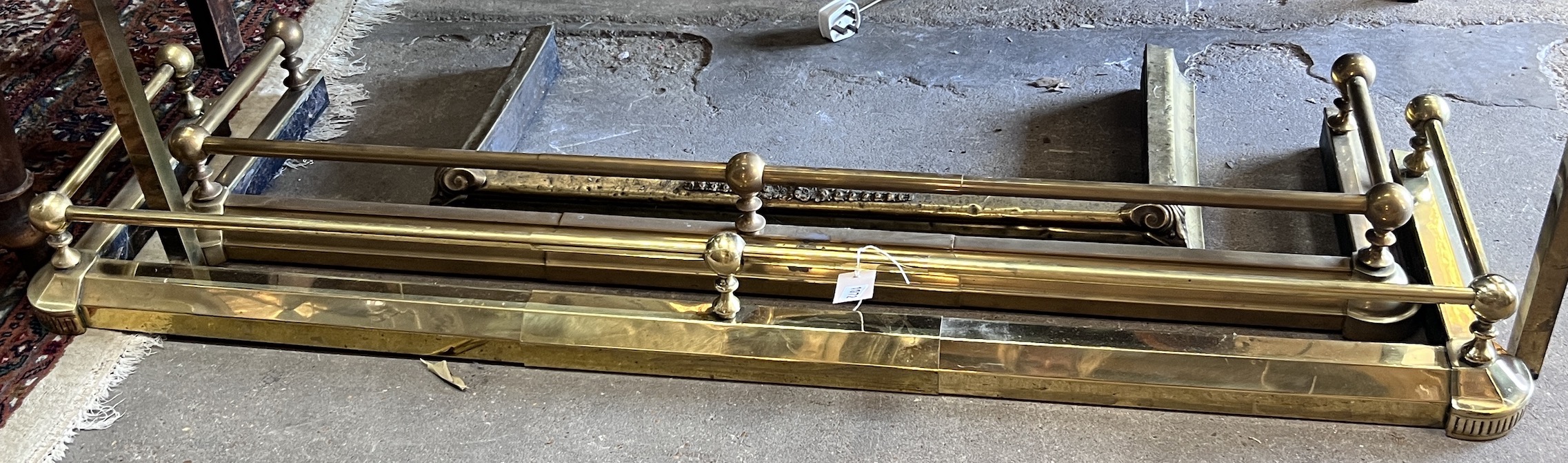 Two Victorian style telescopic brass fenders and a smaller fire curb